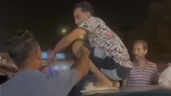 سائق توك توك يهاجم مسنًا وعائلته أثناء وقوفه فوق سيارته
